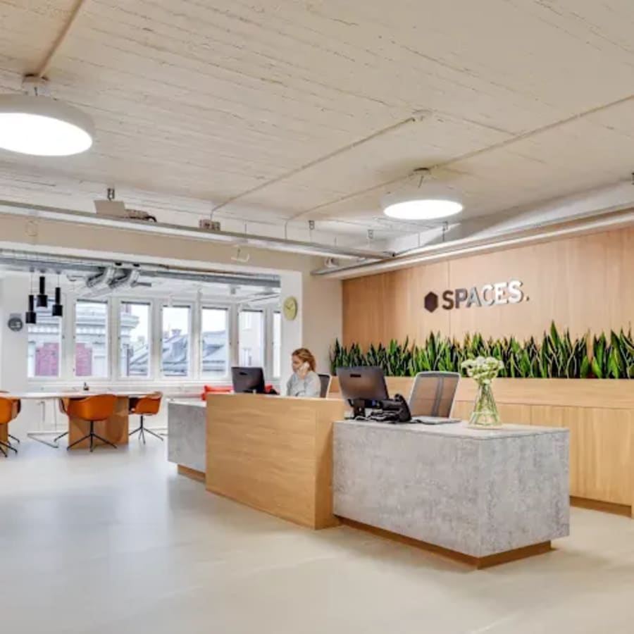 Modern coworking area with natural light, sleek desks, and vibrant seating in Dubai Media City.