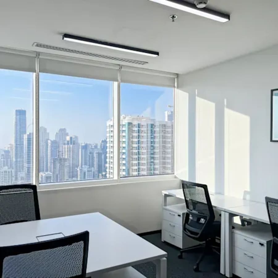 Bright coworking space with stunning skyline views, ergonomic seating, and modern design.