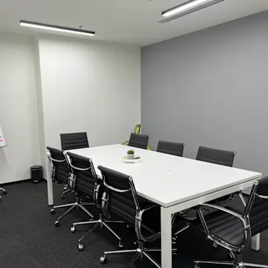 Modern conference room with sleek chairs and ample natural light in DMCC Free Zone coworking space.