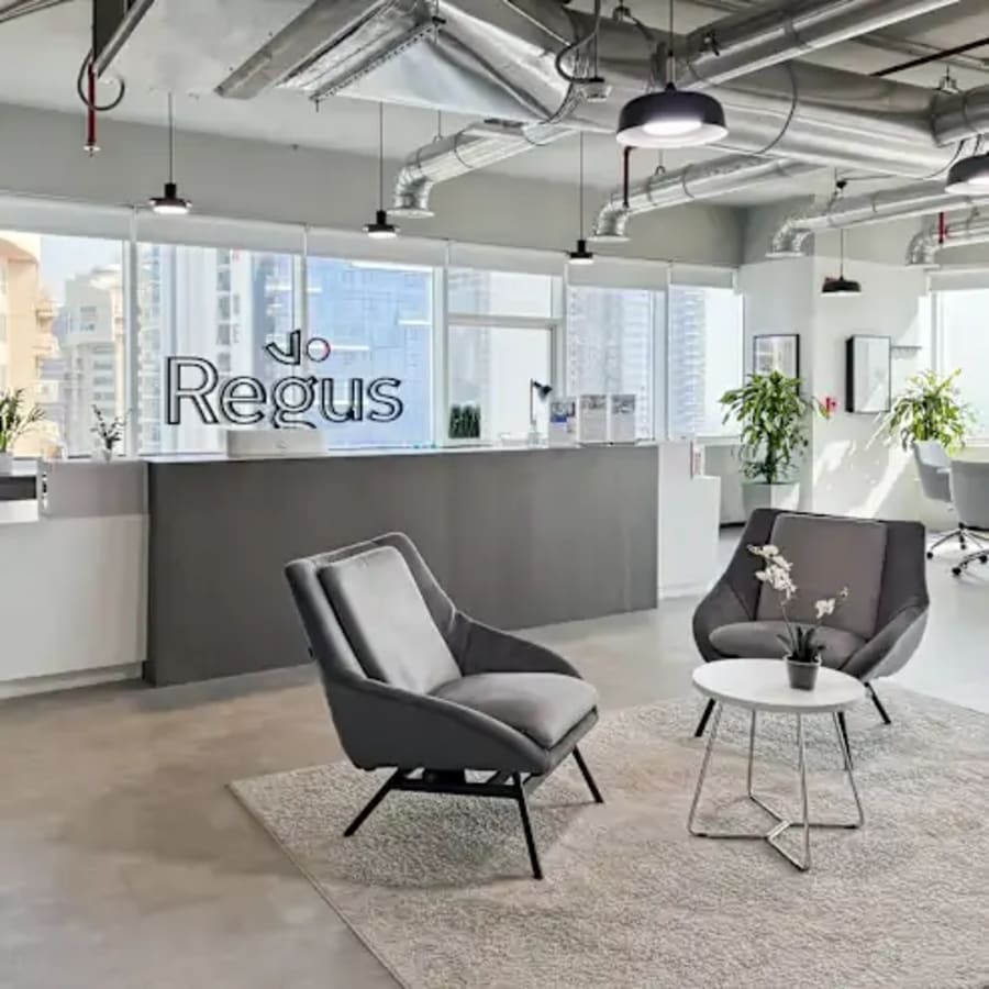 Modern coworking space with sleek seating, abundant natural light, and a stylish reception area.