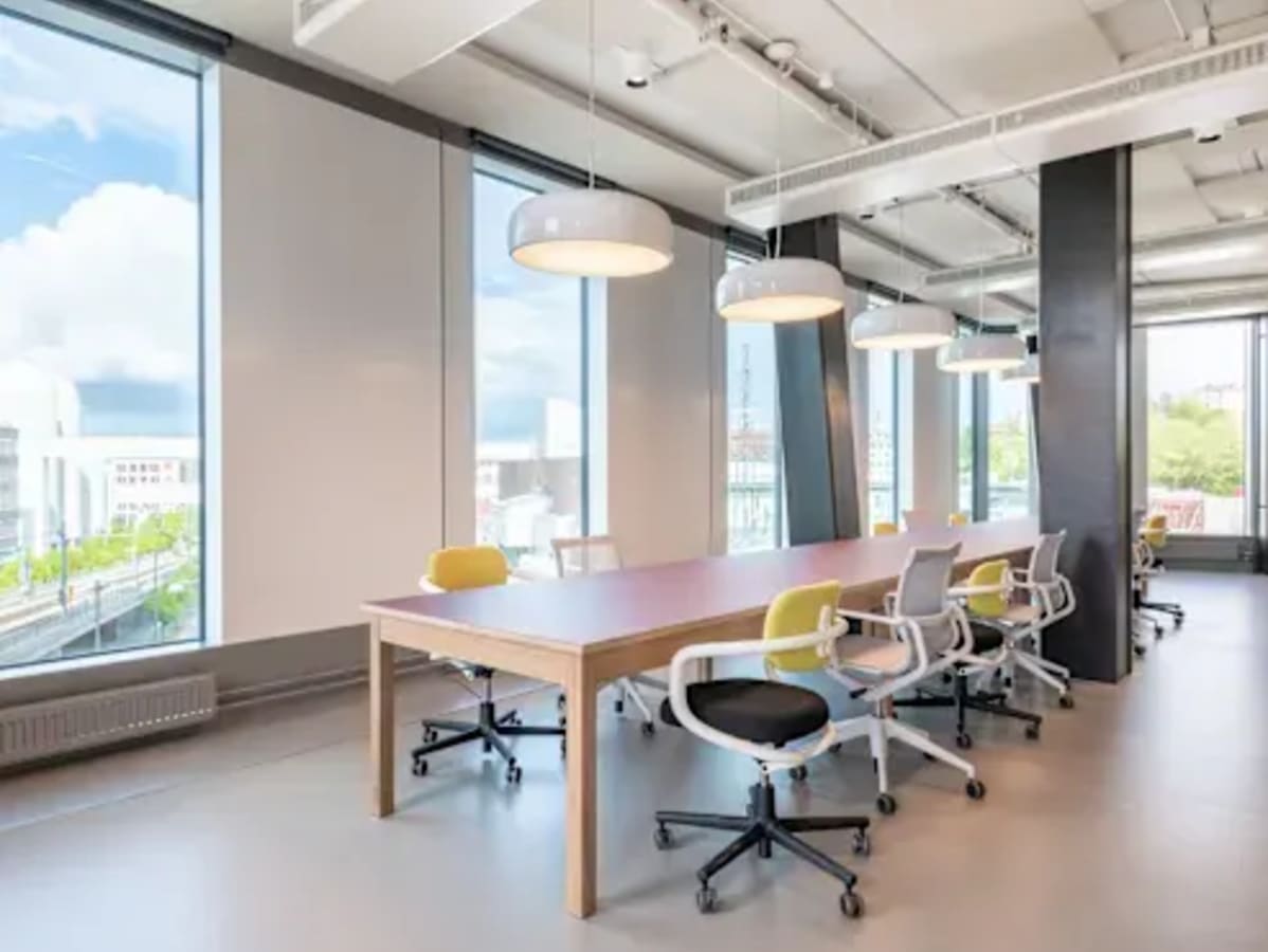 Bright coworking space in Barsha Heights with modern chairs, natural light, and city views.
