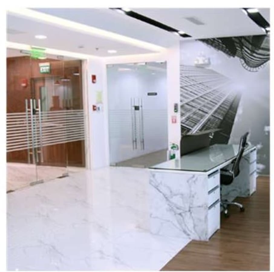Sleek coworking space with modern décor and glass partitions, ideal for productivity.