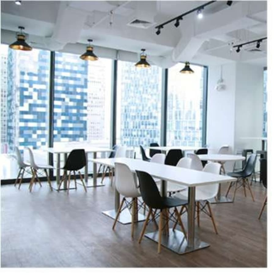 Bright coworking space with modern seating and city views on 3rd Avenue, Metro Manila.