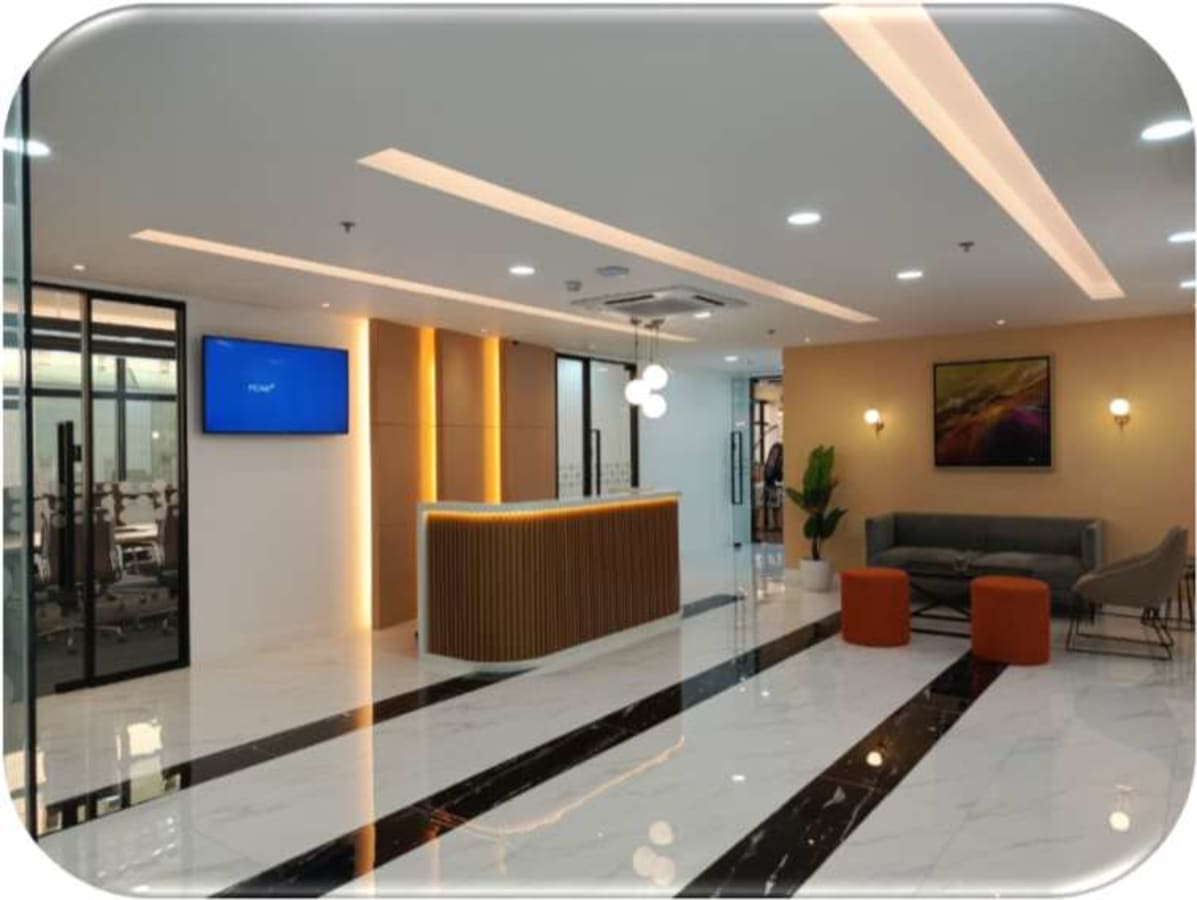 Sleek coworking space with modern reception, cozy seating, and vibrant lighting in Taguig.