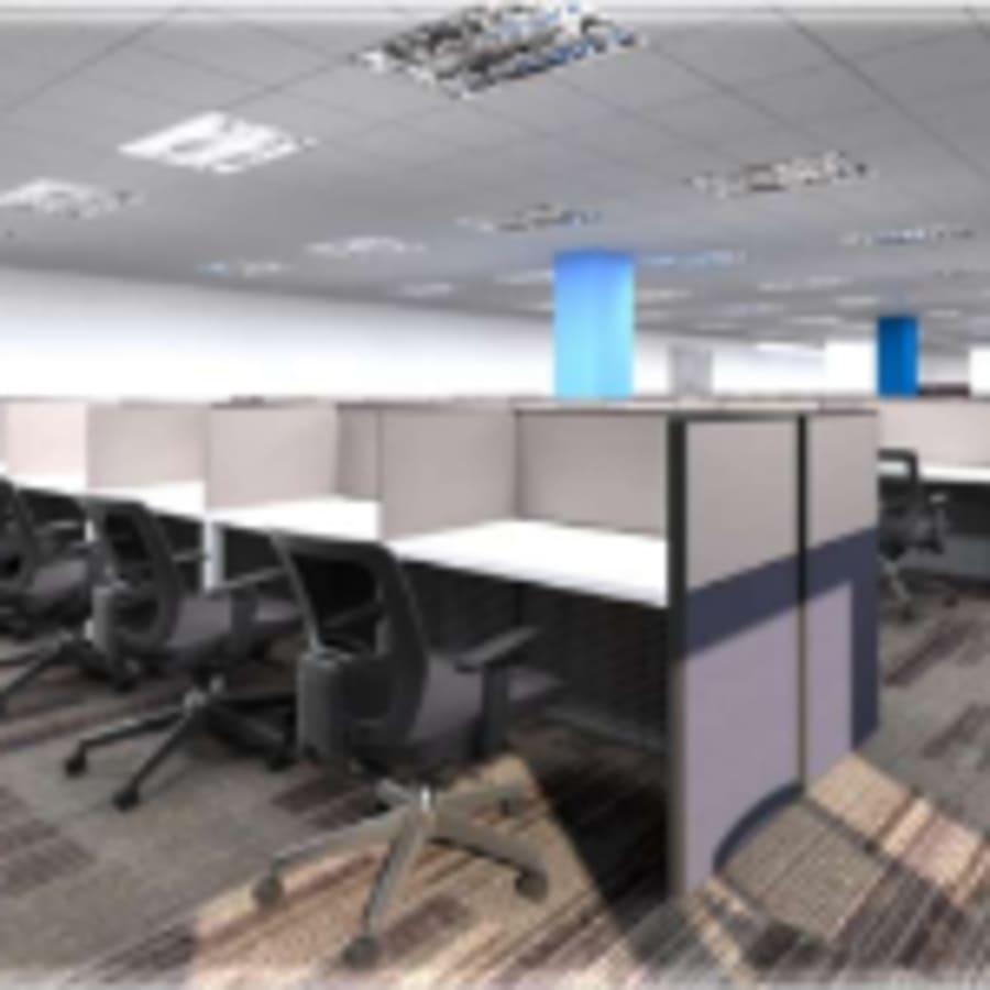 Modern coworking cubicles with ergonomic chairs and ample workspace in a bright, open layout.