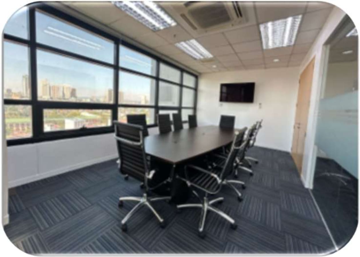 Bright, modern conference room with city views, ideal for meetings and collaborations.