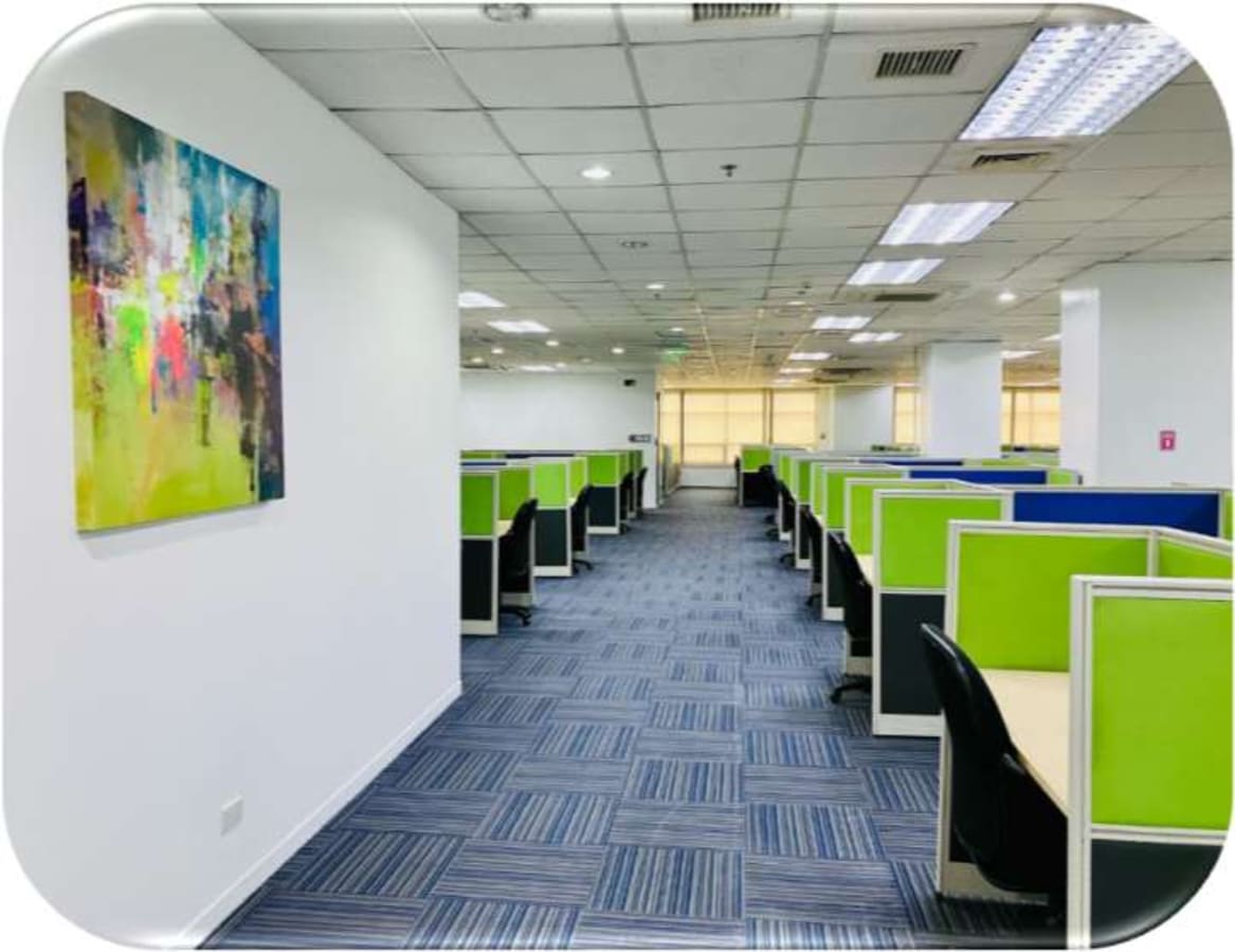 Spacious coworking area with vibrant cubicles and modern design on Kalayaan Avenue. Ideal for productivity.