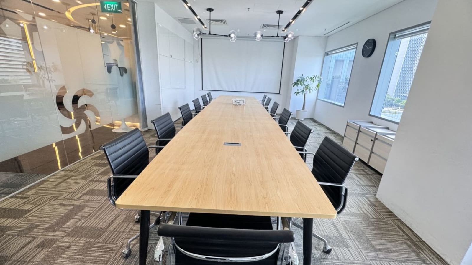 Spacious conference room with modern seating and natural light, perfect for meetings in a prime location.