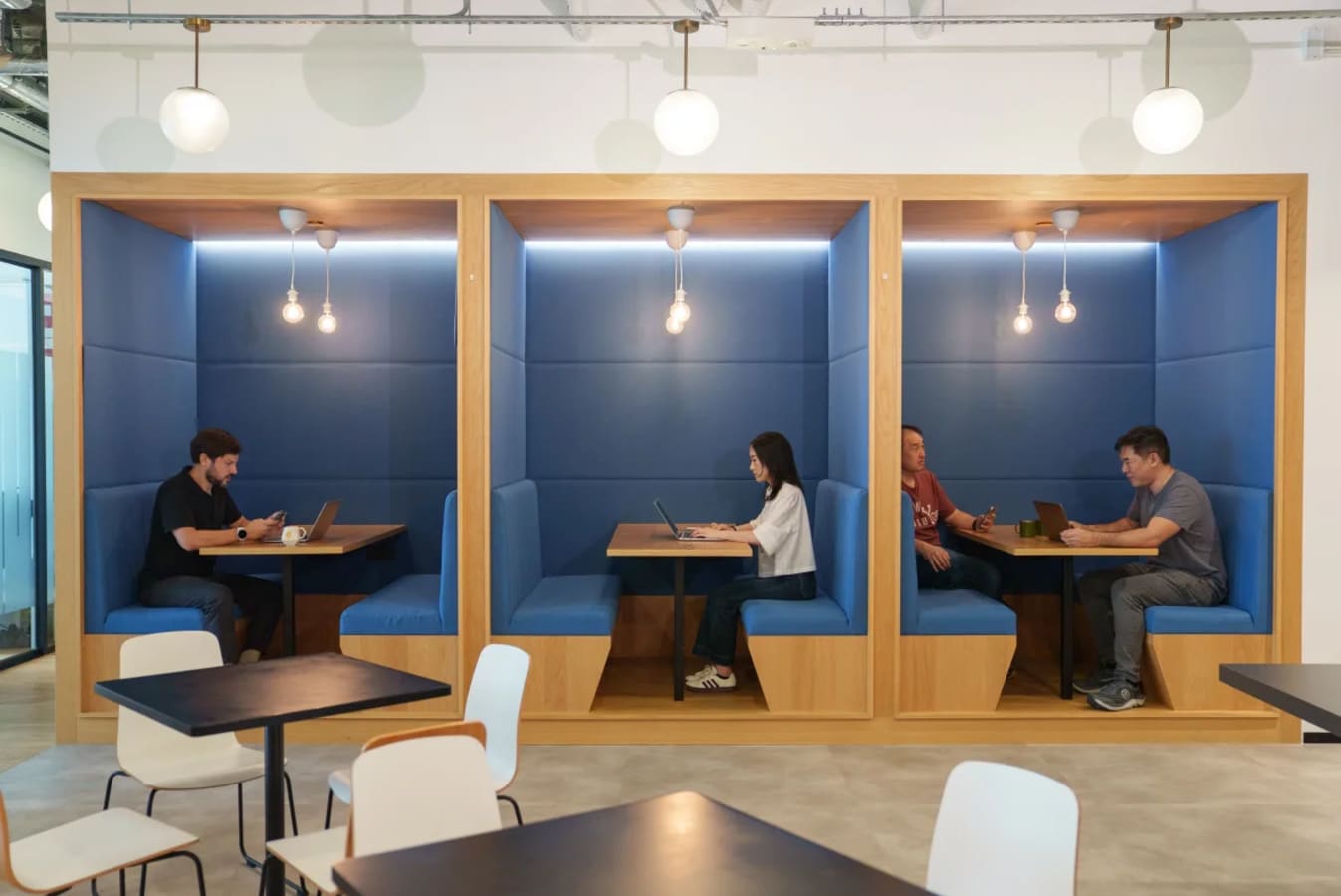 Modern coworking booths with cozy lighting for focused work in Hong Kong Island.