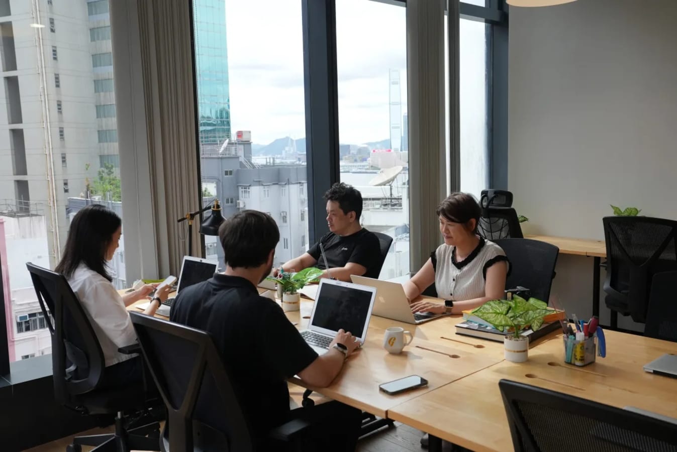 Bright coworking space with large windows, modern desks, and city views on Jaffe Road.