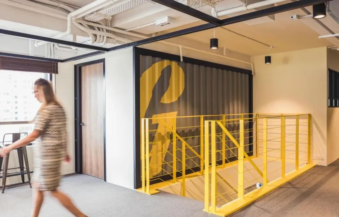 Bright, modern workspace with stylish yellow accents and ample natural light in Queen's Road West.