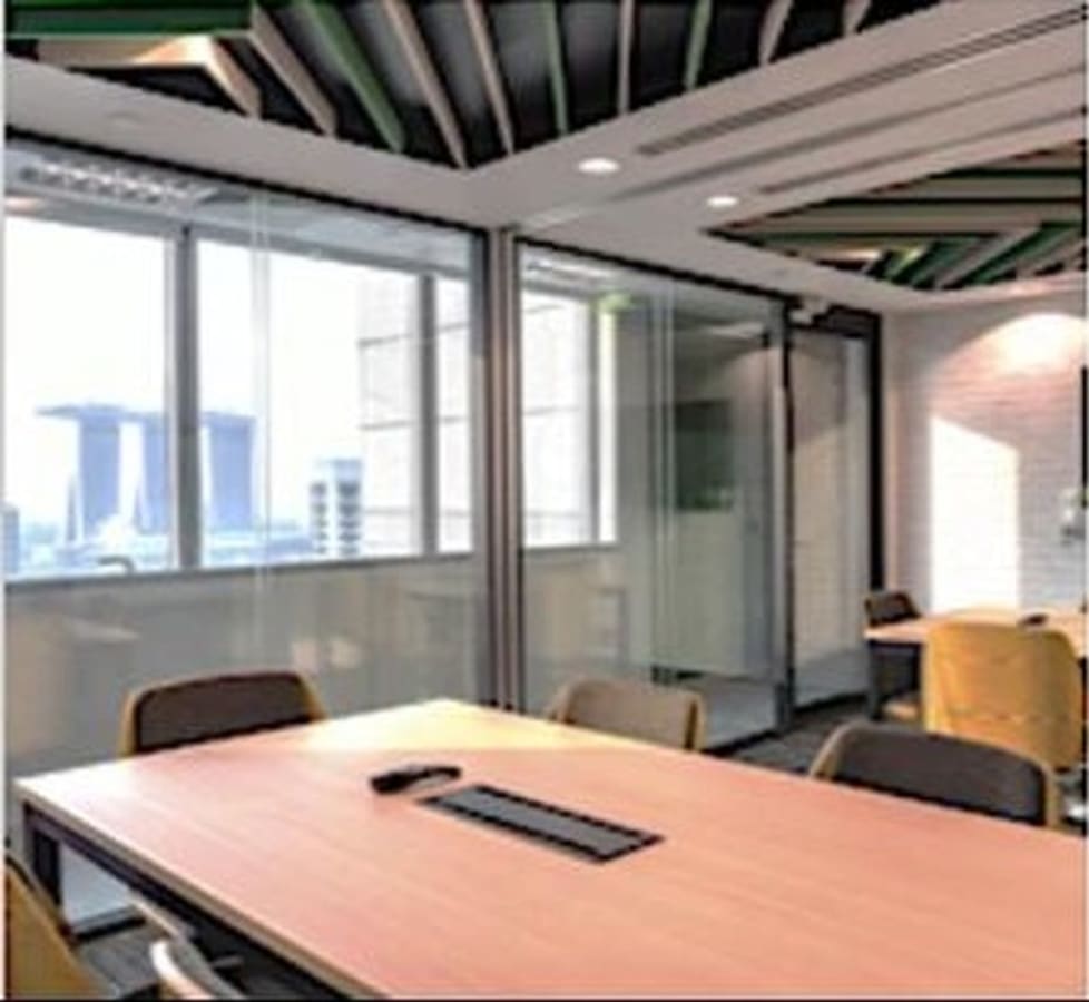 Modern coworking space with natural light, stylish decor, and Marina Bay views. Ideal for collaboration.