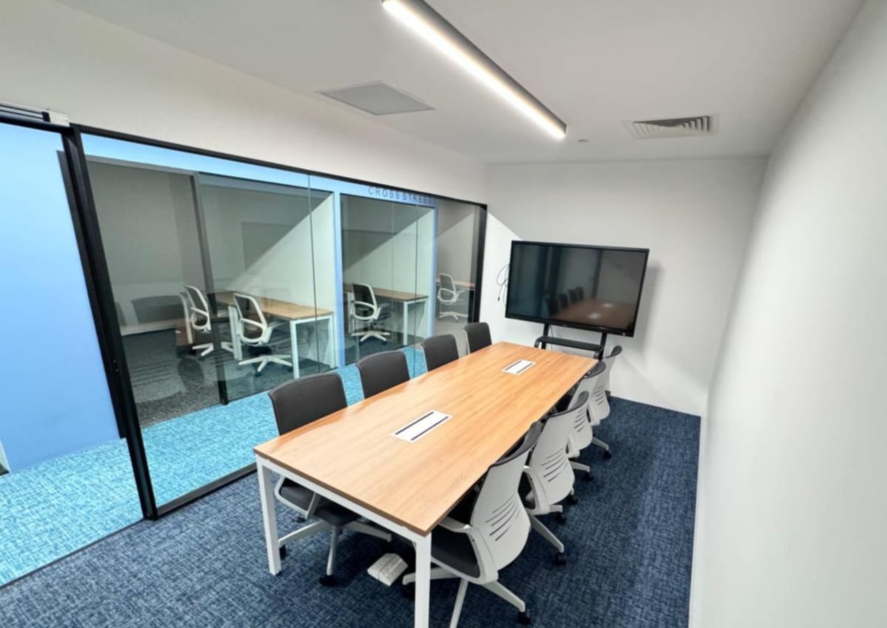 Modern meeting space with ample seating, natural light, and AV setup in Robinson Road.