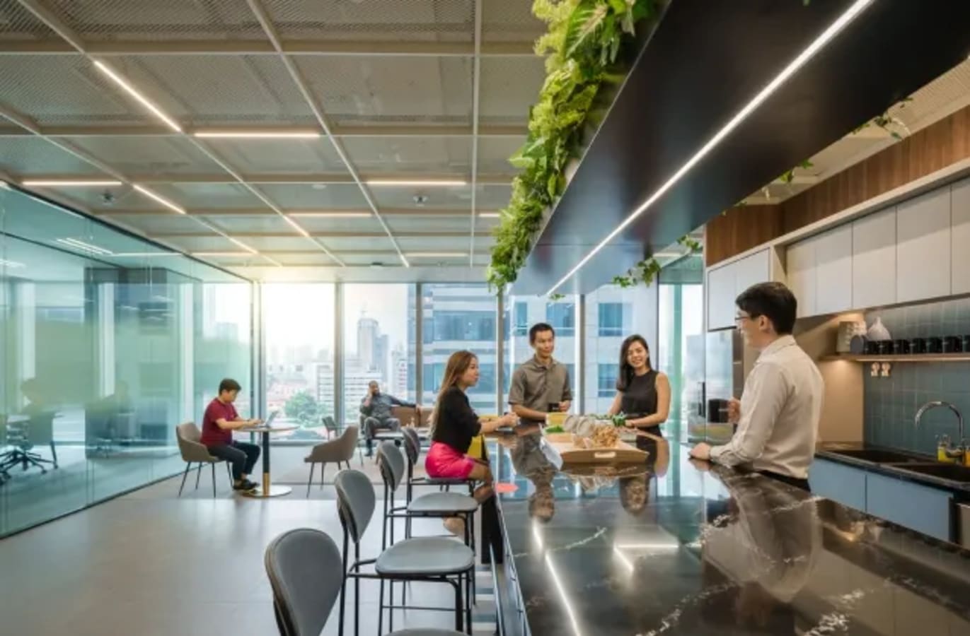 Vibrant coworking space with modern kitchen, natural light, and city views. Ideal for collaboration.