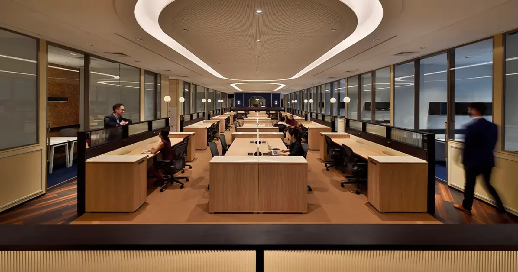 Modern coworking space with sleek desks, ambient lighting, and collaborative areas.