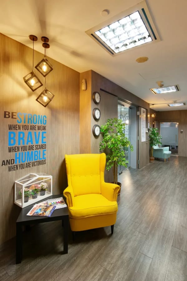 Inviting entry with vibrant seating, motivational decor, and modern lighting. Perfect for collaboration.
