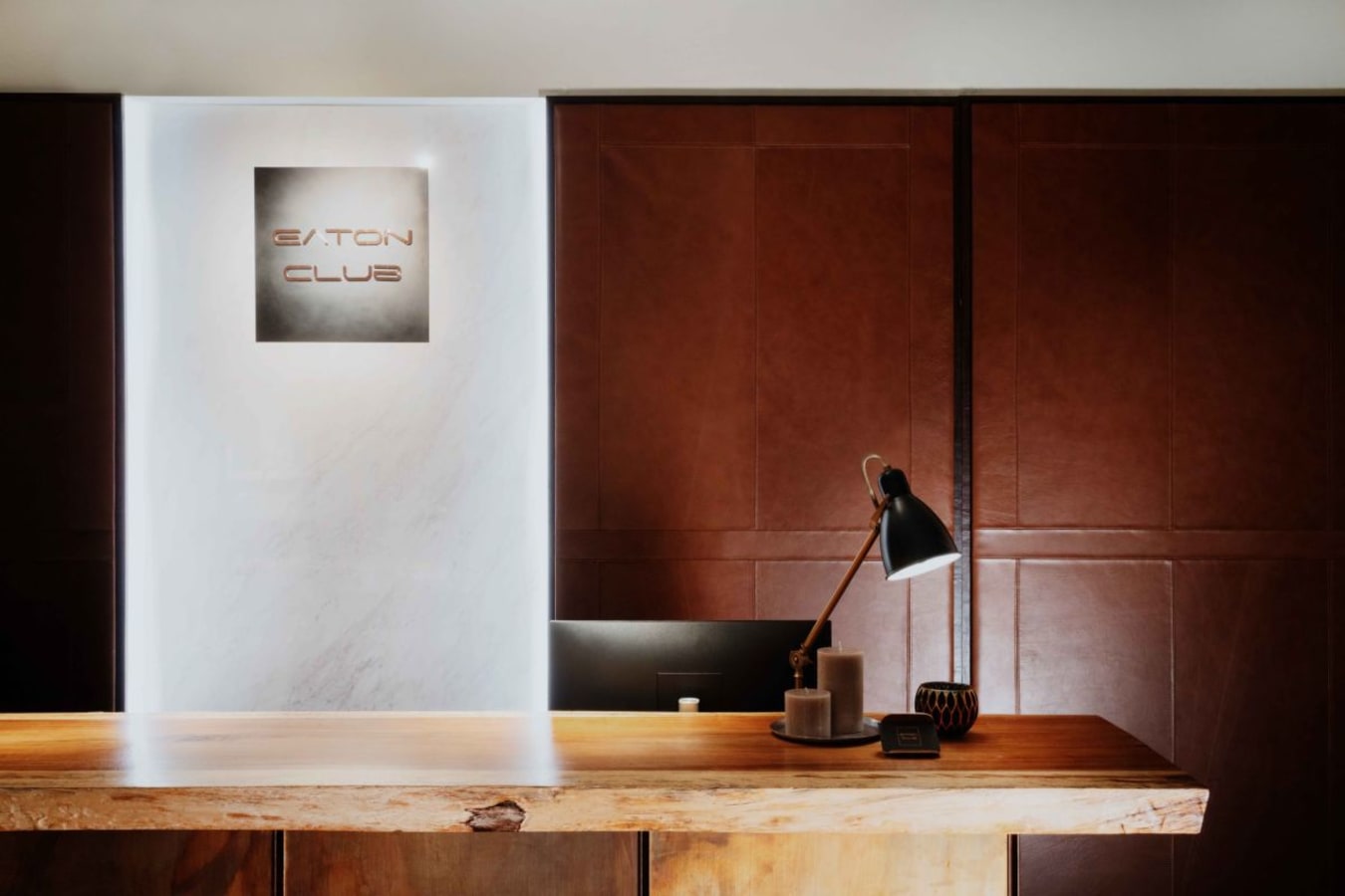 Elegant reception area with warm lighting and stylish wood finish, perfect for a modern workspace.