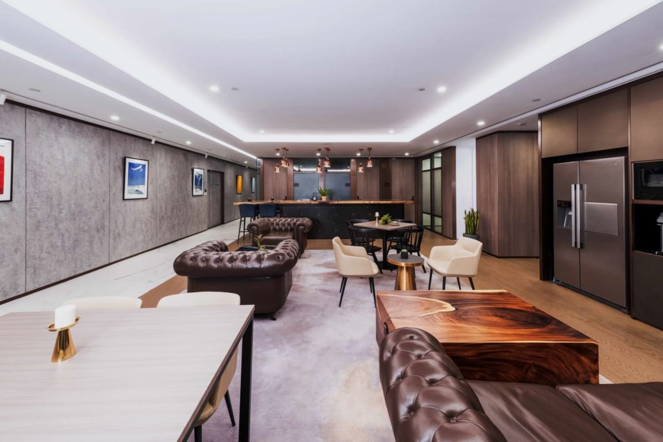 Elegant coworking space featuring plush seating and a sleek kitchen area on Garden Road.