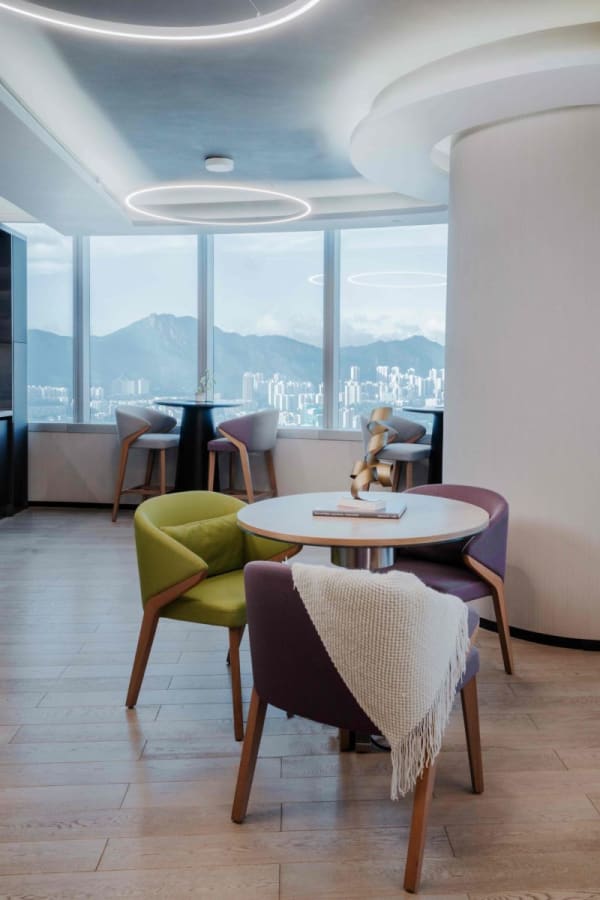 Bright coworking space with modern seating and stunning city views.