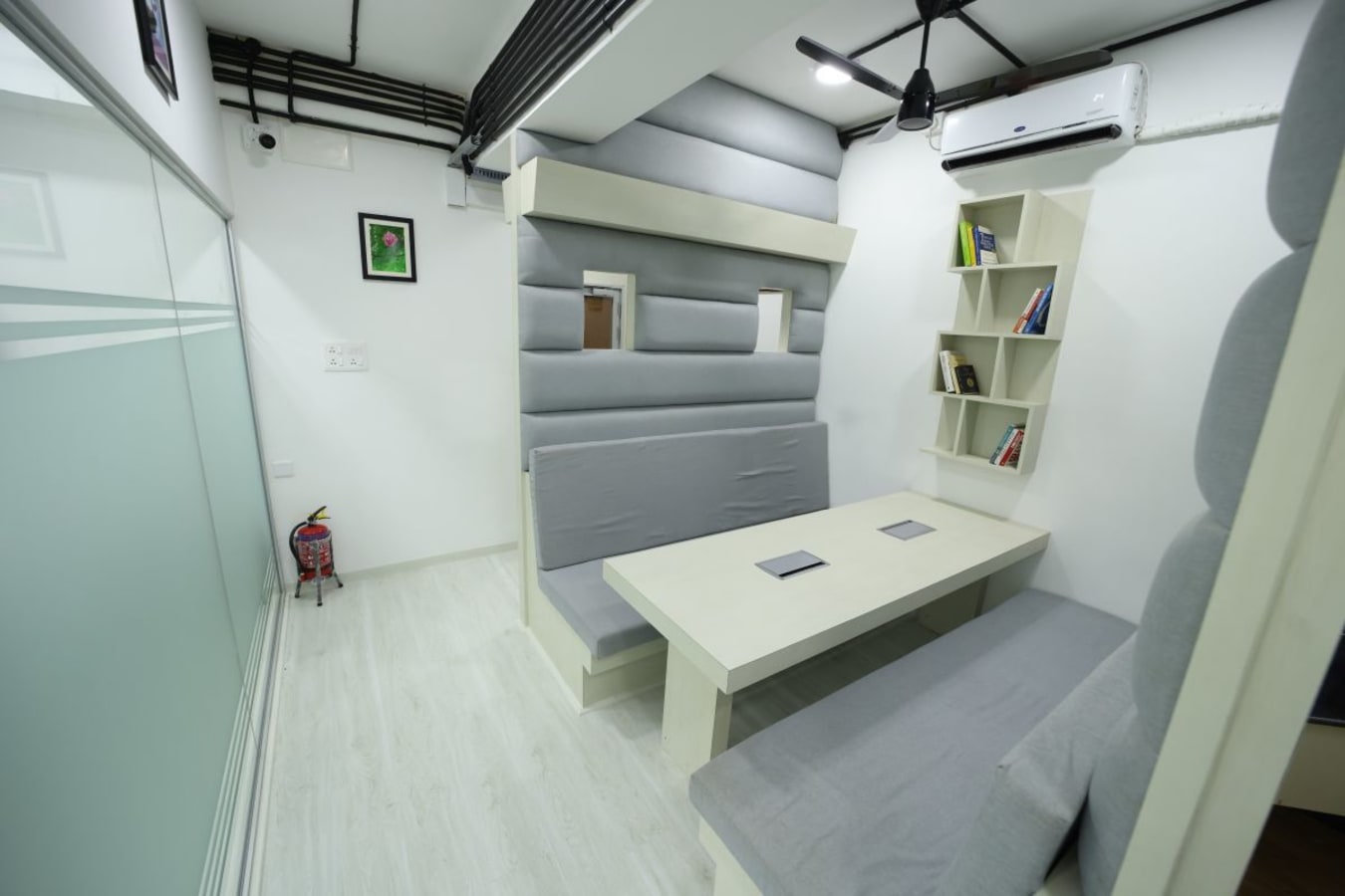 Cozy coworking nook with plush seating, individual tables, and modern decor on Wheat Croft Road.