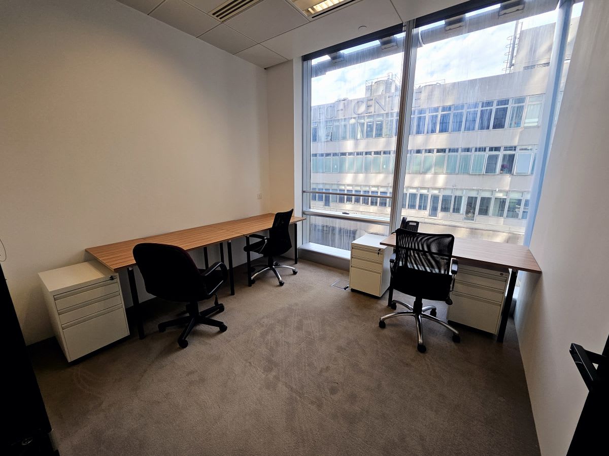 Bright, flexible coworking space with large windows and modern furnishings on How Ming Street.