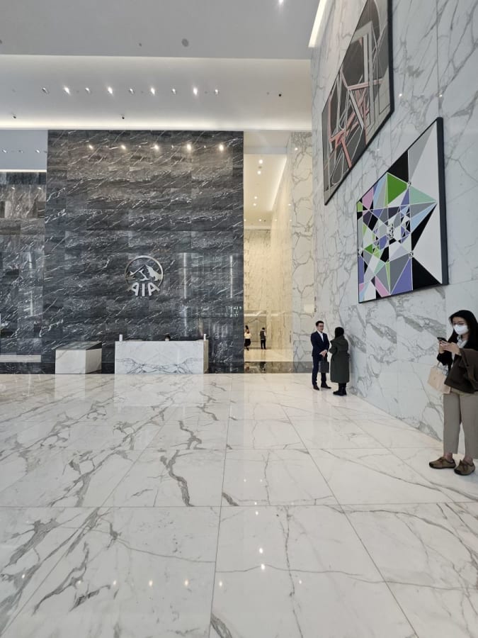 Elegant marble lobby with modern art and welcoming reception area in a prime Kowloon location.