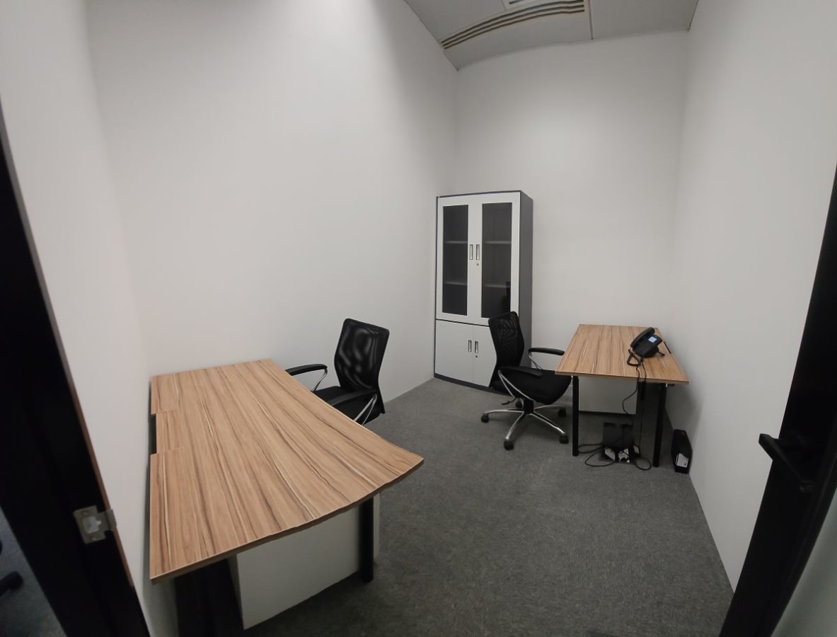 Compact and private office with modern desks, chairs, and a storage cabinet. Perfect for focused work.