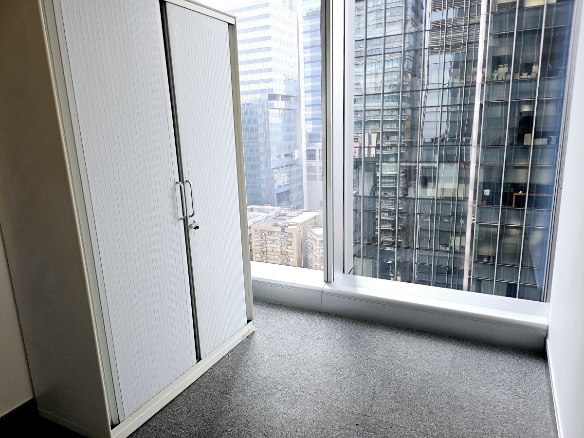 Bright coworking space with floor-to-ceiling windows and city views on How Ming Street.