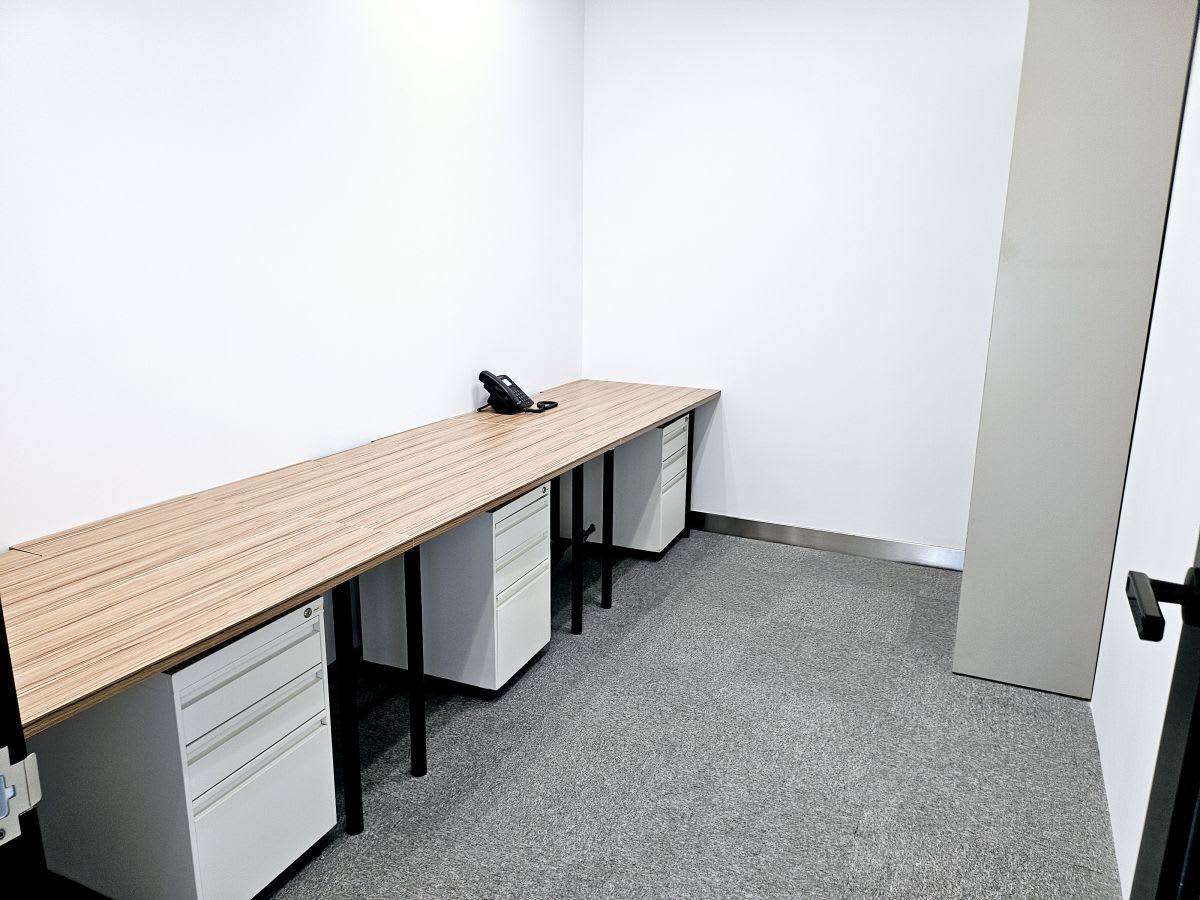 Efficient private workspace with ample desk space and storage, ideal for focused productivity.
