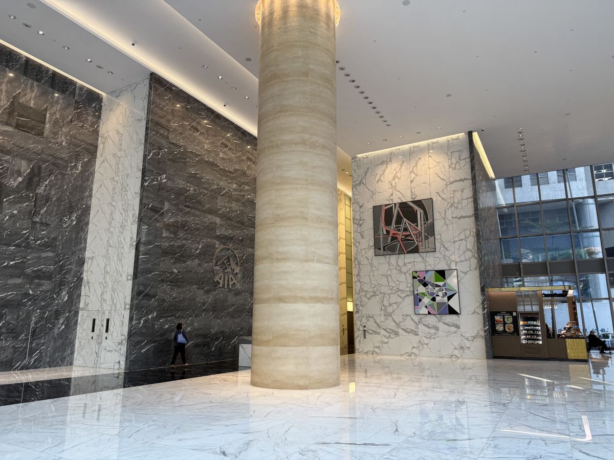 Elegant marble lobby with modern art and ample natural light. Perfect for professionals.