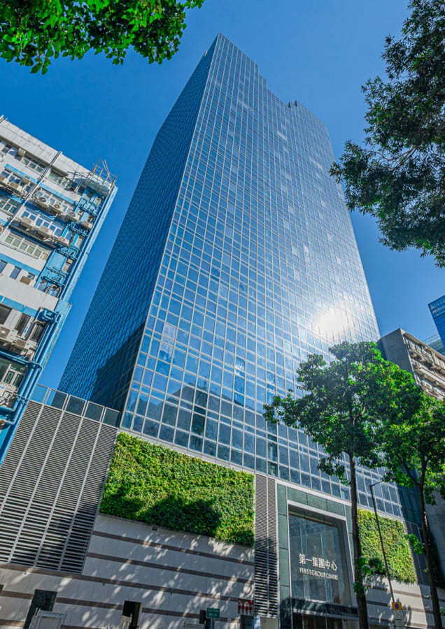 Modern coworking space in a sleek, glass facade building on Wang Chiu Road, Kowloon.