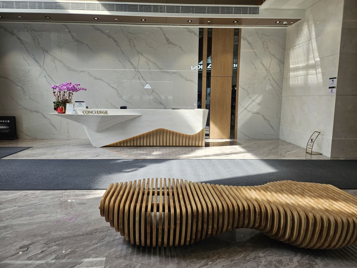 Modern concierge with sleek design and natural light welcomes you to this coworking space.