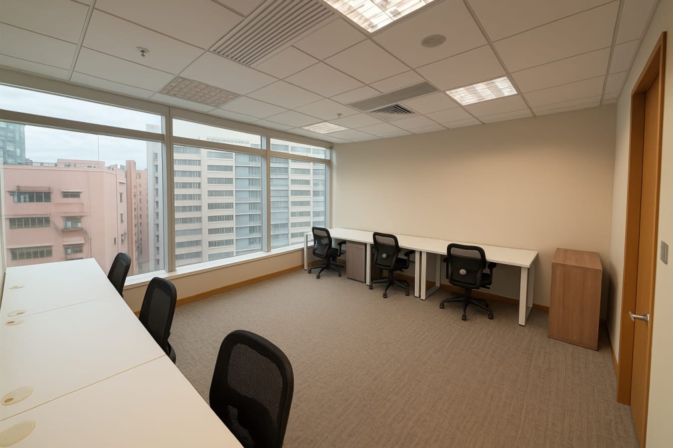 Bright, spacious coworking space with modern desks and city views. Perfect for collaboration.