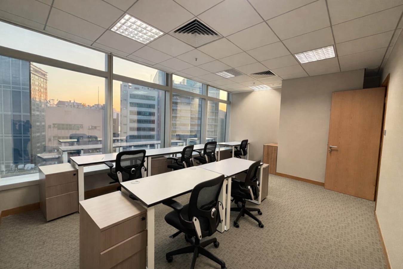 Bright coworking space in Kwun Tong with ergonomic chairs and natural light.
