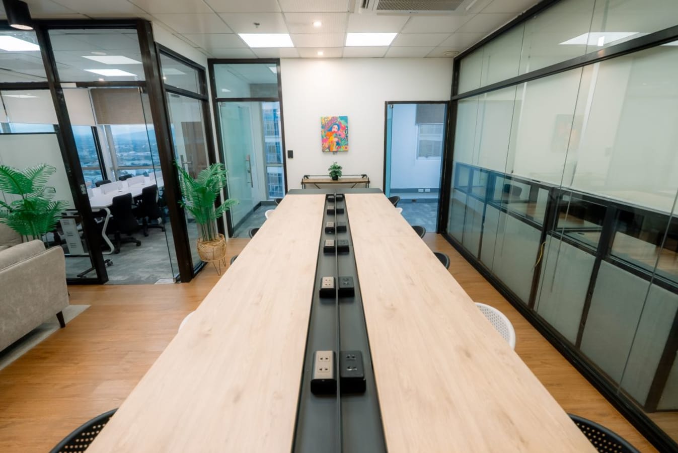 Modern coworking space in Quezon City with spacious tables and private rooms.