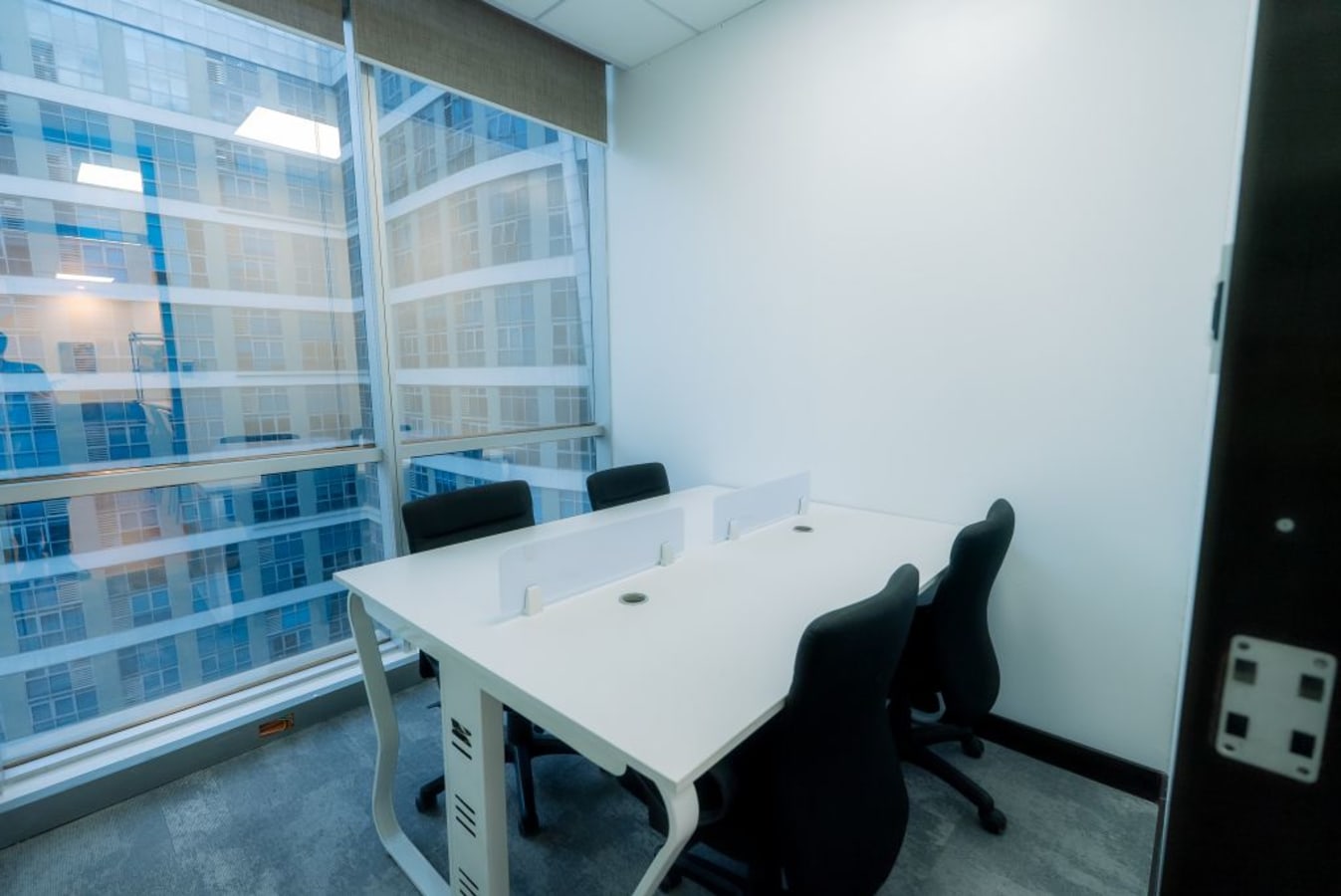 Bright workspace with modern seating and natural light in Quezon City office.