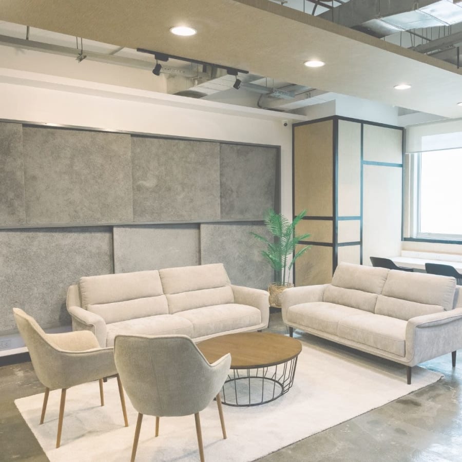 Modern coworking lounge with cozy seating and natural light in Quezon City.