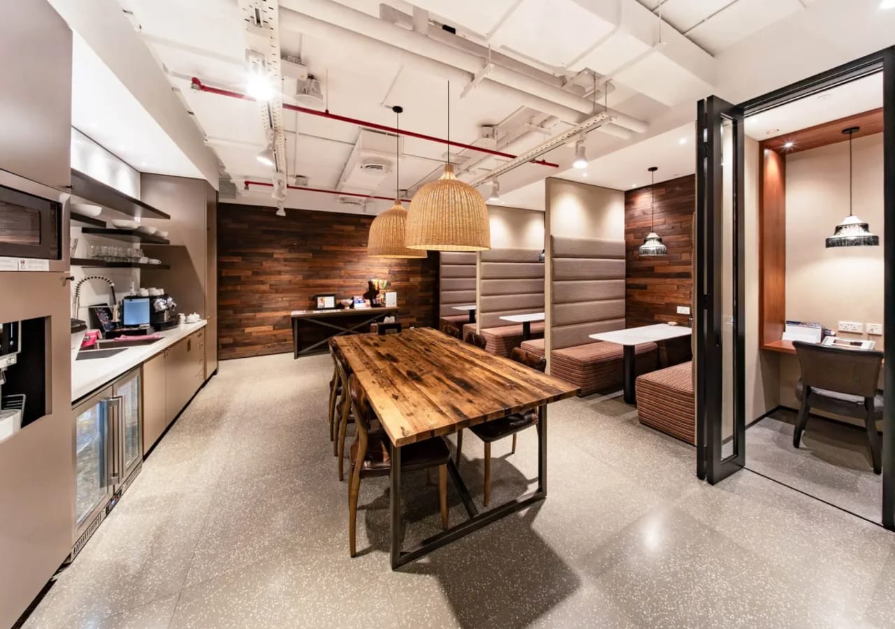 Stylish coworking space with modern amenities, wooden accents, and cozy seating areas in Ho Chi Minh City.