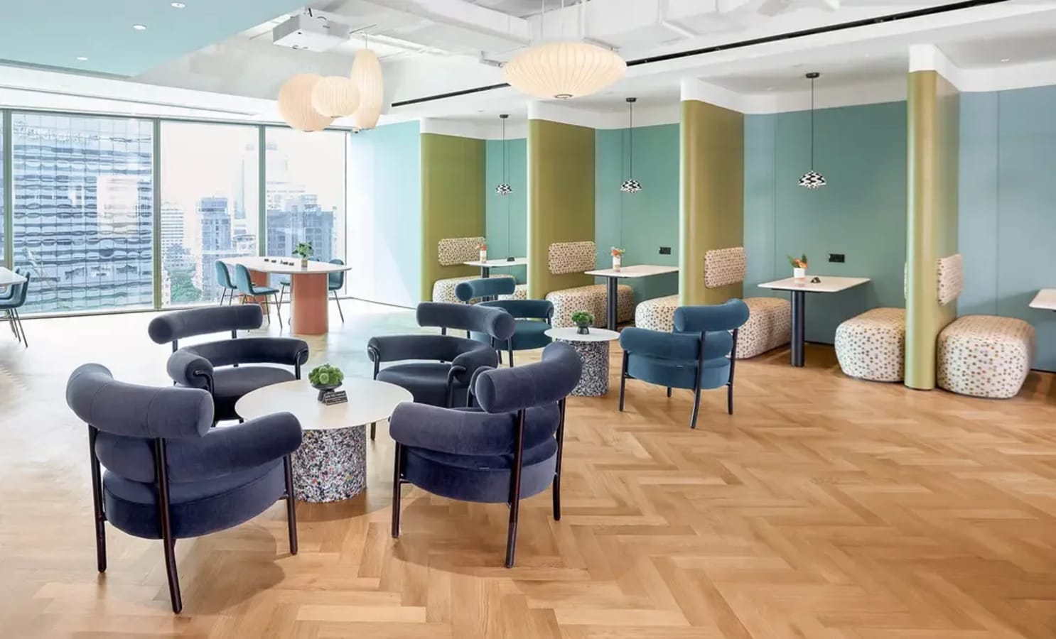 Stylish coworking area with modern seating, natural light, and city views. Ideal for collaboration.