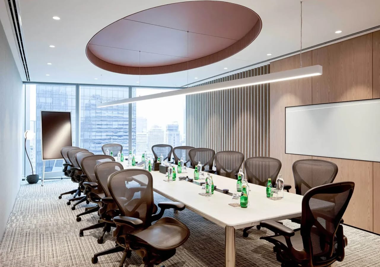 Sleek conference room with modern seating and city views, ideal for dynamic meetings.