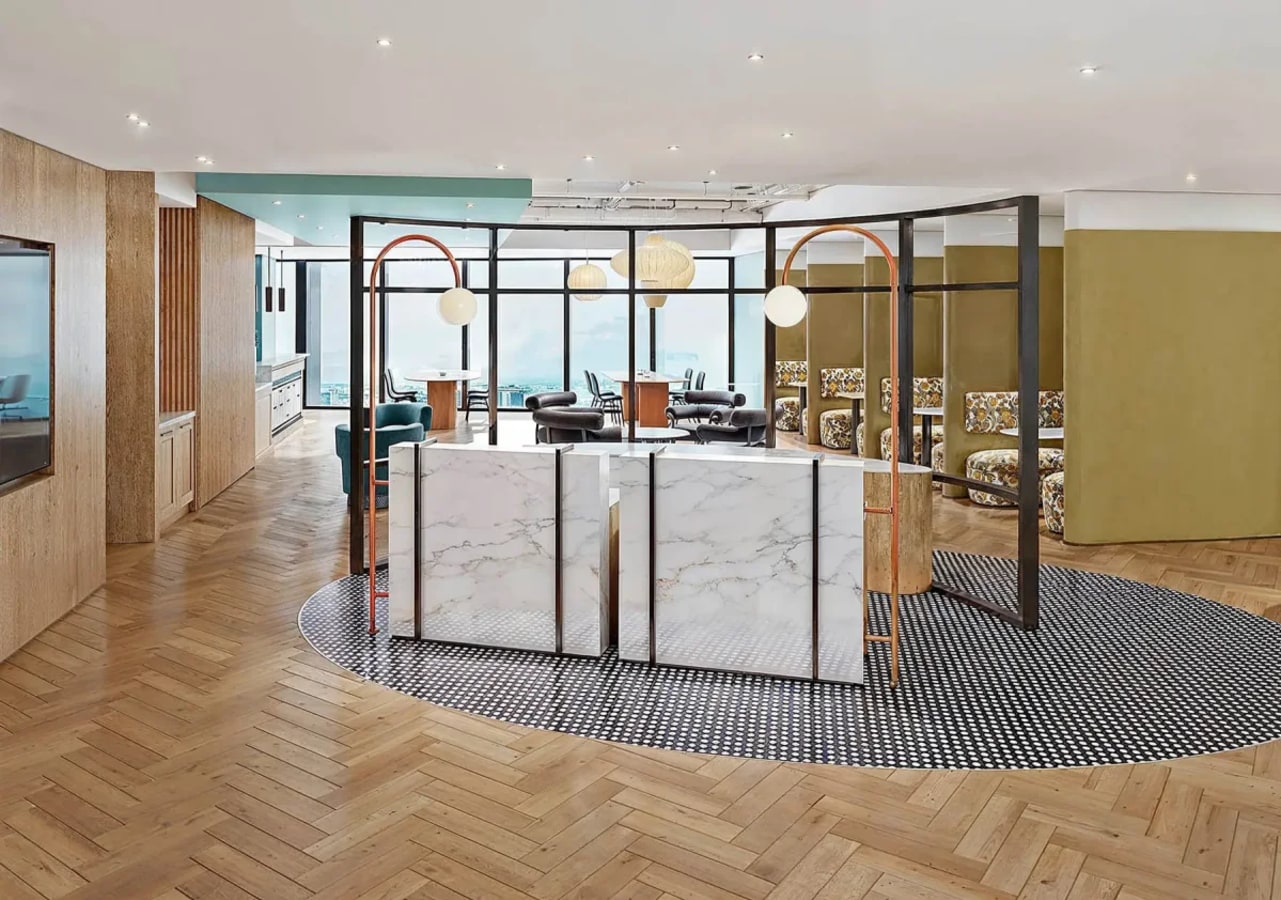 Modern coworking space with stylish partitions, cozy seating, and ample natural light.