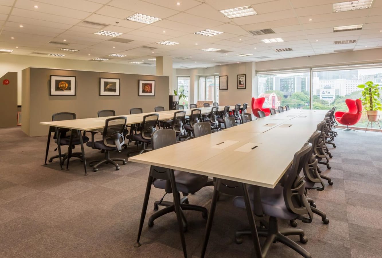 Spacious coworking area with modern desks, ergonomic chairs, and natural light. Perfect for productivity.