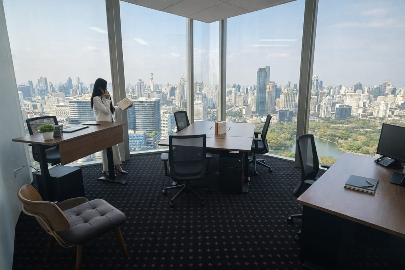 Bright coworking space with panoramic city views and modern furnishings in Bang Rak, Bangkok.