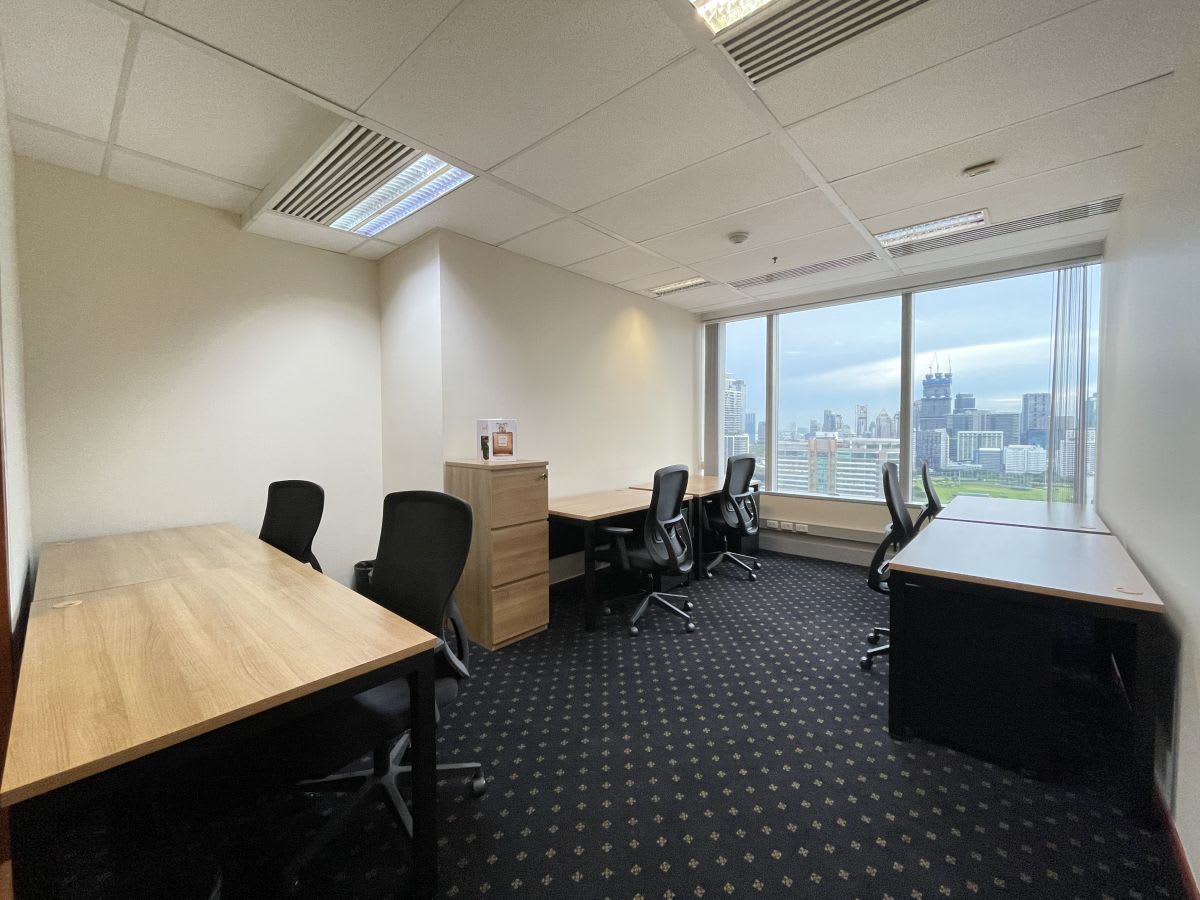 Bright coworking space with city views, ergonomic chairs, and ample desk space in Pathumwan.