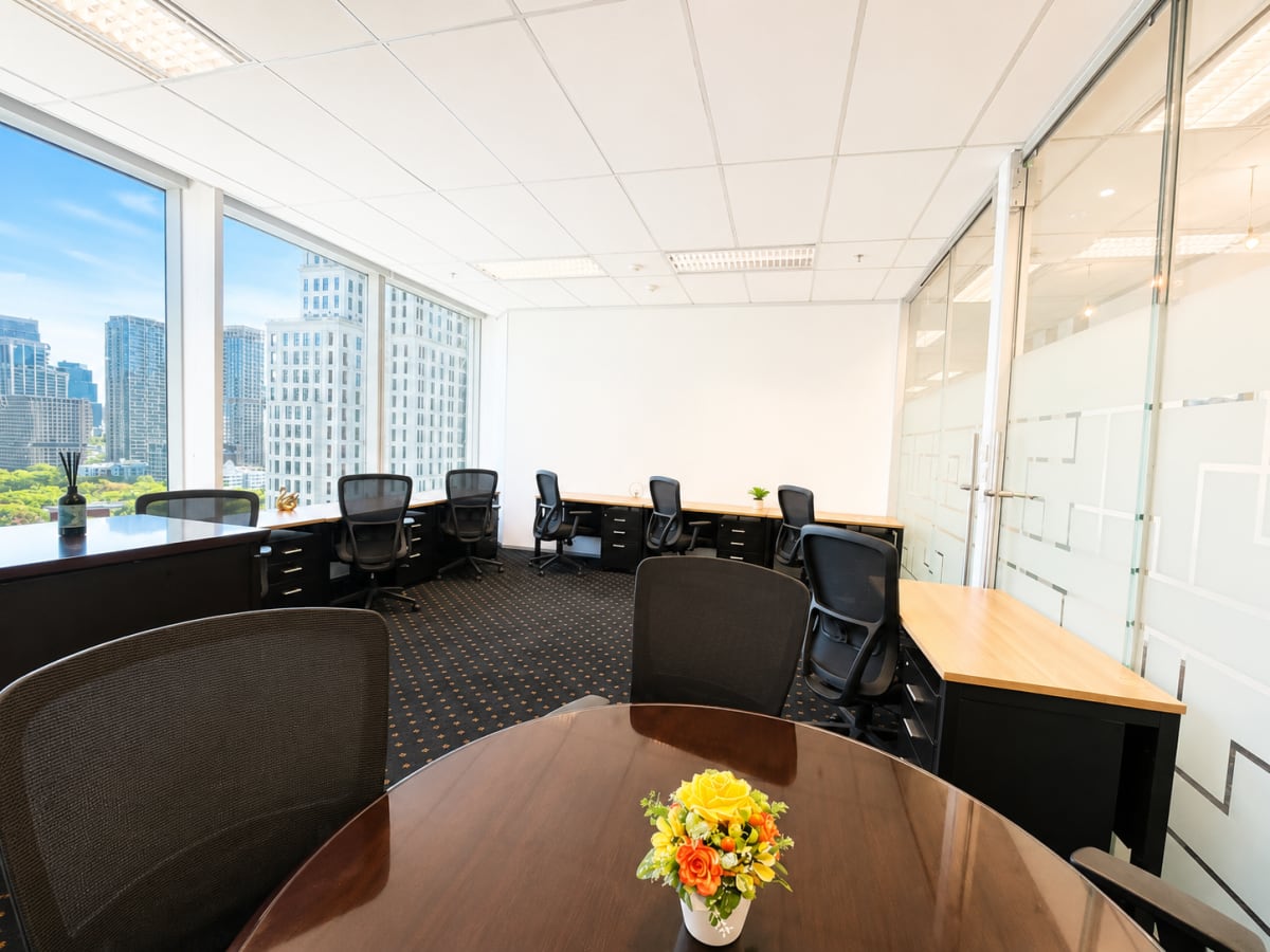 Bright coworking space with city views, modern desks, and sleek decor in Pathumwan.