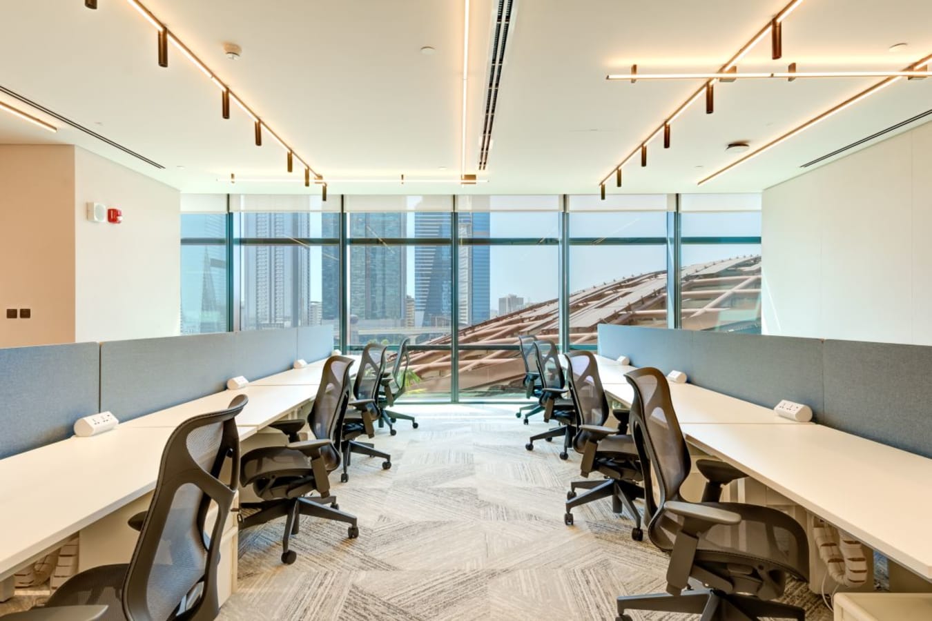 Bright coworking space with ergonomic chairs, modern design, and city views in Za’abeel 1.