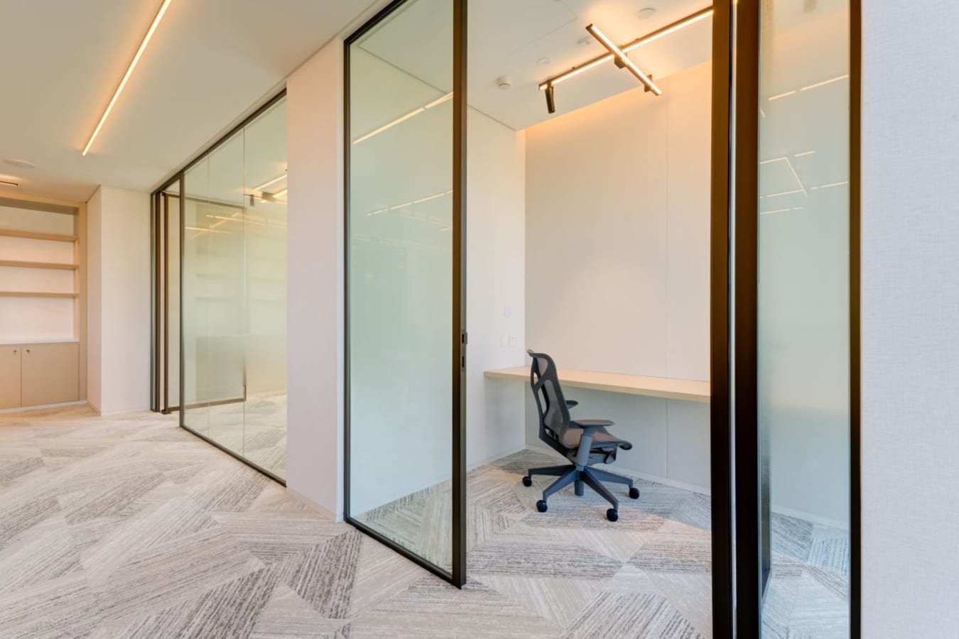 Bright coworking space with sleek glass partitions and modern ergonomic seating in Za’abeel 1.