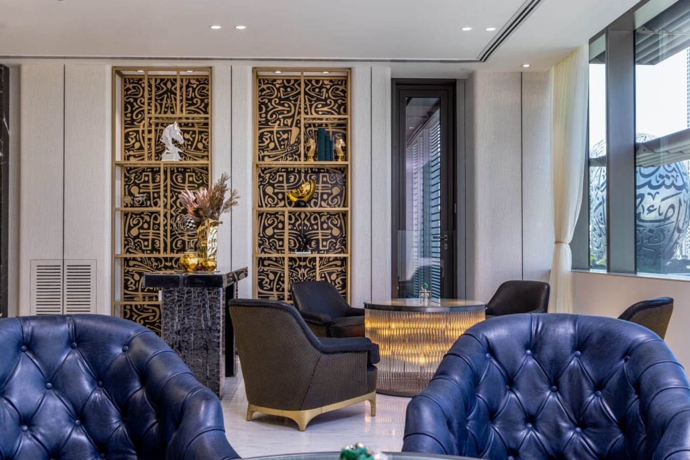 Elegant coworking space with plush seating, artistic décor, and ample natural light on Sheikh Zayed Road.