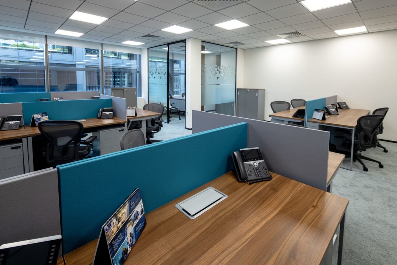 Modern coworking space with modular desks, ergonomic chairs, and natural light. Ideal for productivity.