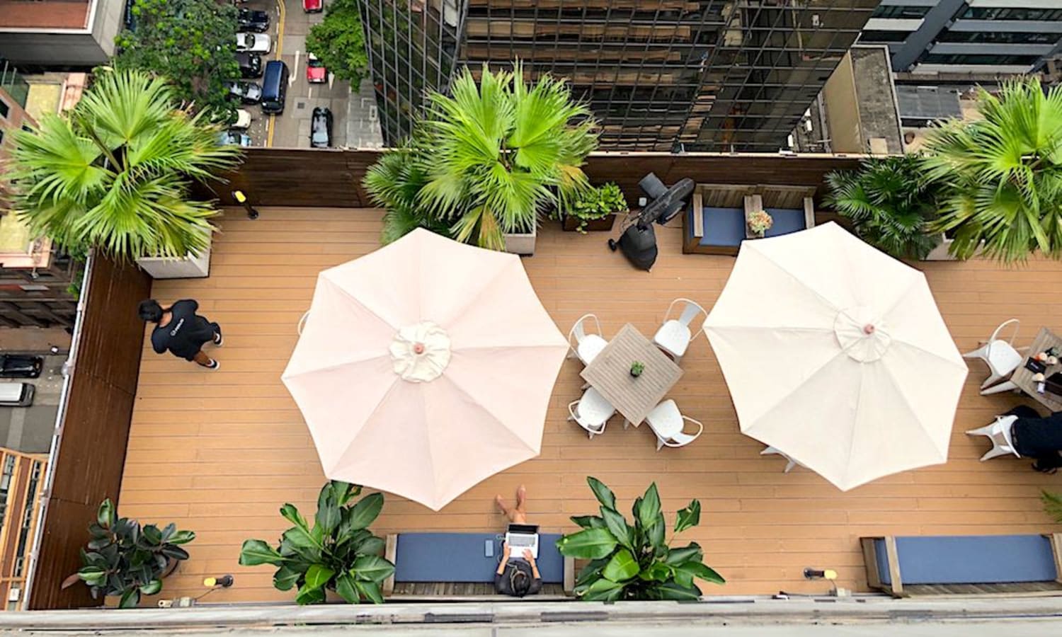 Stylish outdoor terrace with seating and greenery, perfect for networking or a relaxing break.